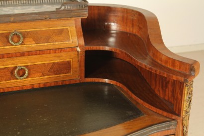Scrittoio da centro, scrittoio dalla linea mossa.cassetto sotto-piano, piano estraibile, inserto in pelle, vani a giorno, cassettini sagomati con pianetto in marmo. Riserve a marquetterie e fregi.