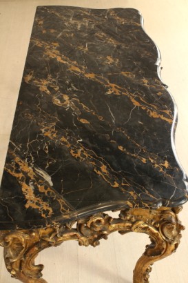 Richly carved, gilded console table leg moves, marble top, polished, shaped portoro