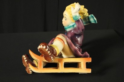 Garçon en céramique de traîneau à chiens